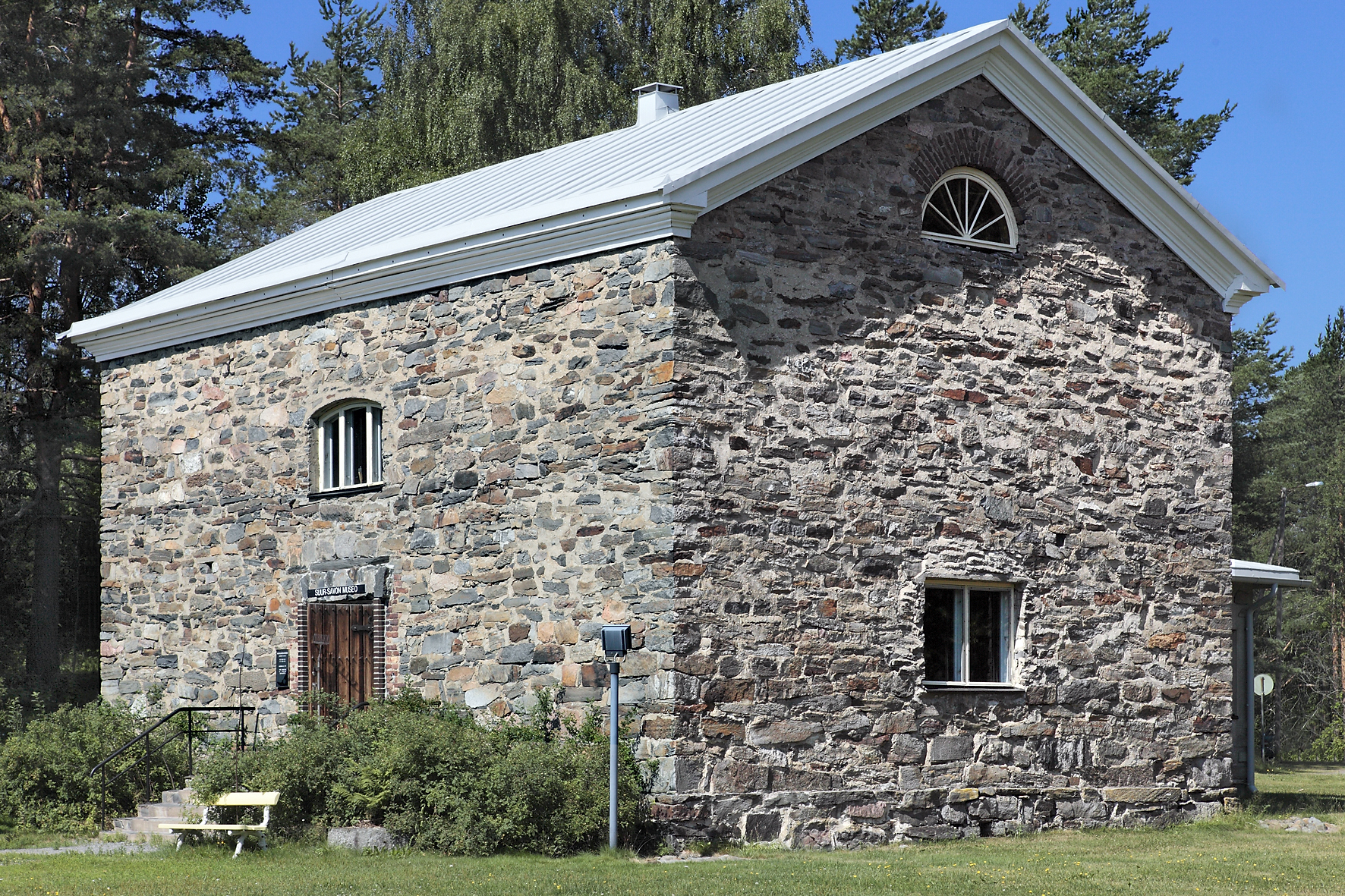 Kivistä rakennettu nelikulmainen rakennus, jossa on pienet ikkunat. 